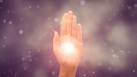 Hand with glowing light in palm